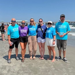 people posing for a picture on a beach