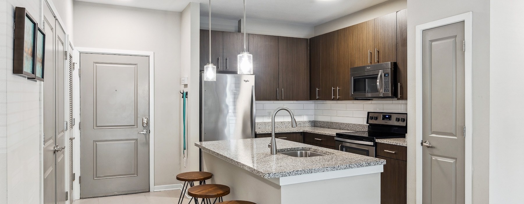 a kitchen with an island and bar stools