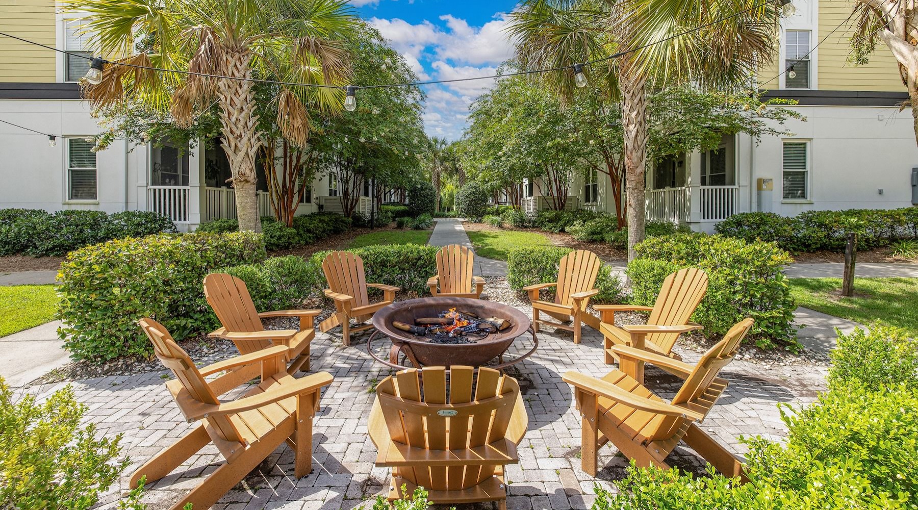 a fire pit with lounge chairs