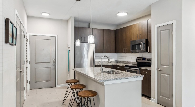 a kitchen with an island and bar stools