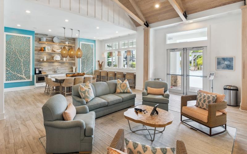 a clubroom with a couch, tables and chairs