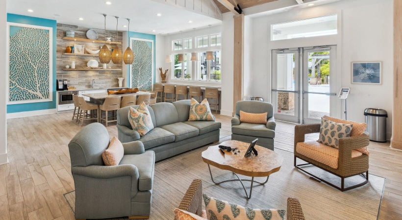 a clubroom with a couch, tables and chairs