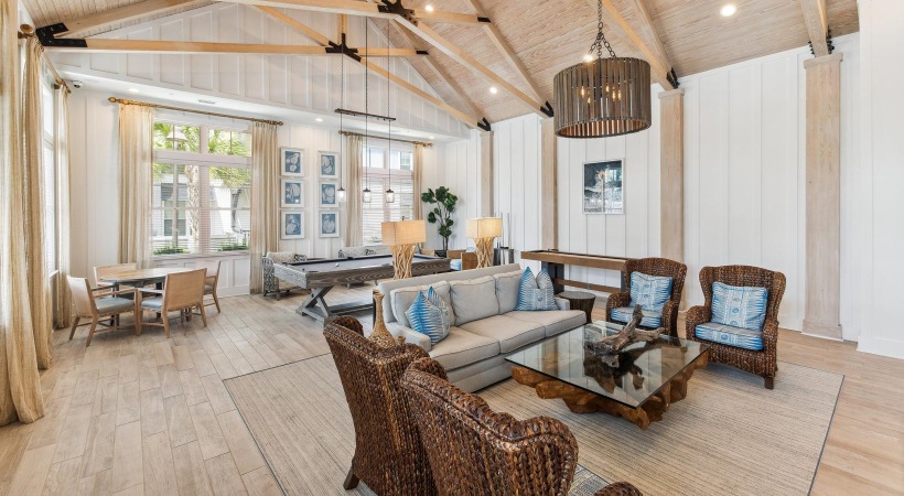 a clubroom with a couch, tables and chairs